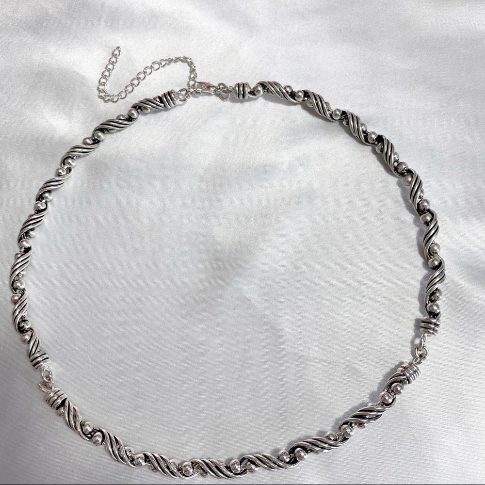 Silver tone necklace, jointed in three places for a comfortable fit. 3” chain.